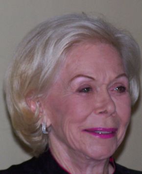 Head-and-shoulders photograph of an older woman with short fair hair, smiling